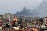 Columns of smoke rising from heavy shelling in the Jobar neighborhood in west Damascus, in Cairo, Syria, Thursday, Aug. 22, 2013.