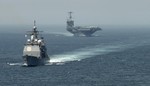 The guided-missile cruiser USS Gettysburg, left, and the aircraft carrier USS Harry S. Truman transit the Strait of Gibraltar en route to the Mediterranean Sea, 3 August, 2013.