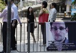 A banner supporting Edward Snowden, a former CIA employee who leaked top-secret documents about sweeping U.S. surveillance programs, is displayed at Central, Hong Kong's business district, Wednesday, June 19, 2013.