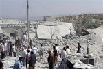 In this citizen journalism image provided by Edlib News Network, ENN, which has been authenticated based on its contents and other AP reporting, Syrians search under rubble to rescue people from houses that were destroyed by a Syrian government warplane, in Idlib province, northern Syria, Friday, Aug. 30, 2013.