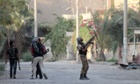 A rebel fighter points his weapon at regime forces in an industrial area of Syria's eastern town of Deir Ezzor.