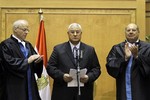 Egypt's chief justice Adly Mansour, center, is applauded by by chiefs of the constitutional court after he is sworn in as the nation's interim president Thursday, July 4, 2013. The chief justice of Egypt's Supreme Constitutional Court was sworn in Thursday as the nation's interim president, taking over hours after the military ousted the Islamist President Mohammed Morsi.