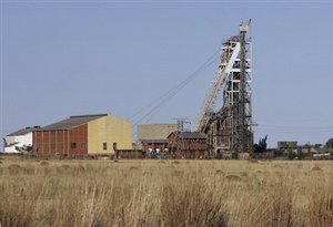 No. 8 Shaft at the St. Helena Gold Mine is seen outside Welkom, South Africa, one of the centers of South Africa's gold mining industry, Wednesday Oct. 10, 2007. Twenty-five bodies have been brought up to the surface at No. 8 Shaft after the illegal miners died from toxic fumes or got caught in a fire 1,500 meters (5,000 feet) underground. South Africa is the world's largest producer of gold and as the bullion price has risen, and legal mines dig ever deeper to meet the world's voracious demand, so have the risks these "gold pirates" are prepared to incur in pursuit of the precious metal. (AP Photo/Peter Dejong)hg3