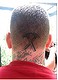 A tattoo on the back of Kenneth Stewart's head.