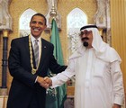 President Barack Obama shakes hands after receiving a gift from Saudi King Abdullah at the start of their bilateral meeting at the King's Farm in Riyadh, Saudi Arabia, Wednesday, June 3, 2009.