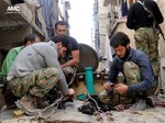 File - In this Thursday, April 25, 2013 file photo citizen journalism image provided by Aleppo Media Center AMC which has been authenticated based on its contents and other AP reporting, shows members of the free Syrian Army preparing their weapons, in the neighborhood of al-Amerieh in Aleppo, Syria.