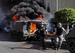 Medics transport an injured Lebanese soldier, after clashes between followers of a radical Sunni cleric Sheik Ahmad al-Assir and Shiite gunmen, in the southern port city of Sidon, Lebanon, Sunday, June 23, 2013.