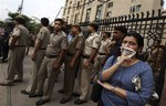 Delhi policemen stand guard as they secure a gate after protesters broke through a police barrier and entered the court complex demanding the death penalty for the four men convicted in the fatal gang rape of a young woman on a moving New Delhi bus last year, in New Delhi, India, Wednesday, Sept. 11, 2013.