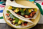 Tortillas with spicy tomato, fish and black beans.