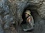 A man enters one of the tunnels dug with shovels in the Shinkolobwe Cobalt mine on Saturday, the mine is situated, 35km from the town of Likasi, in South Eastern, Democratic Republic of Congo, April 10, 2004. Amid world terror fears and concerns about unregulated nuclear materials, Congo's president issued a strict decree: The mining zone that provided uranium for the atomic bombs America unleashed on Hiroshima and Nagasaki must close immediately.