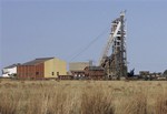 No. 8 Shaft at the St. Helena Gold Mine is seen outside Welkom, South Africa, one of the centers of South Africa's gold mining industry, Wednesday Oct. 10, 2007. Twenty-five bodies have been brought up to the surface at No. 8 Shaft after the illegal miners died from toxic fumes or got caught in a fire 1,500 meters (5,000 feet) underground. South Africa is the world's largest producer of gold and as the bullion price has risen, and legal mines dig ever deeper to meet the world's voracious demand, so have the risks these "gold pirates" are prepared to incur in pursuit of the precious metal. (AP Photo/Peter Dejong)hg3