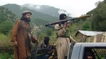 In this file photo taken on Sunday, Aug. 5, 2012, Pakistani Taliban patrol in their stronghold of Shawal in Pakistani tribal region of South Waziristan.