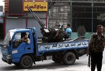 In this Sunday, July 29, 2012 photo, Free Syrian Army soldiers are seen at the border town of Azaz, some 20 miles (32 kilometers) north of Aleppo, Syria. The U.N. said 200,000 Syrians have fled the embattled city of Aleppo since intense clashes between regime forces and rebels began 10 days ago.