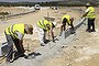 A group of municipal job-lottery winners work on the construction of an industrial park in Alameda, Spain, July 15, 2013. Once a month, the city, which has an almost 50 percent unemployment rate, raffles off temporary public jobs to citizens who are out of work. (Samuel Aranda/The New York Times)