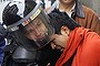 People confront riot policemen who are trying to arrest a protester in downtown Mexico City.