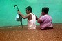 A couple wades in a flooded street in Acapulco, Guerrero state, Mexico.