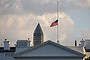 A flag flies at half mast above the White House.