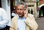 Pakistan tour manager Zaheer Abbas speaks on the phone as he walks towards the team bus at the Oval, London, Monday Aug. 21, 2006.Pakistan forfeited The Oval Test match against England Sunday Aug. 20, after failing to take the field for the final session in a protest against being penalised for ball-tampering