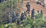 Soldiers from the Kenyan Defense Forces gather at the entrance to the Westgate Mall in Nairobi, Kenya Thursday, Sept. 26, 2013.