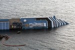 The cruise ship Costa Concordia leans on its side after running aground the tiny Tuscan island of Giglio, Italy, Tuesday, Jan. 17, 2012.