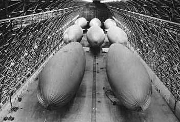 Blimps in hangar, looking much like large bombs