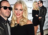 Lovebirds: Jenny McCarthy canoodled with her beau Donnie Wahlberg as she hosted a party at 1Oak in Las Vegas, Nevada on Saturday night