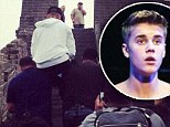 All hail Emperor Bieber! Justin 'CARRIED up Great Wall Of China by bodyguards after skateboarding around town as security sprints behind him'