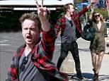 Can't bring him down! Aaron Paul's still riding high on overwhelming success of Breaking Bad finale as he enjoys lively stroll with wife Lauren