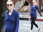 Taking a walk on the wild side! Pregnant Jaime King jazzes up her outfit with animal print flats as she displays her growing baby bump in a clingy cowl neck top