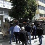 An angry Cypriot depositor drives an excavator into an ATM