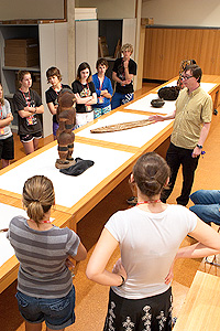 image: Pacific Art Curator Crispin Howarth with students in the Collection Study Room