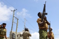 Police hold their positions outside the Masjid Mussa mosque as they attempt to suppress demonstrators reacting to the killing of an Islamic cleric at Kenya's coastal city of Mombasa