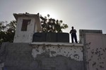 A guard stands atop a watchtower at a UN compound attacked in the Somali capital of Mogadishu on June 27, 2013.