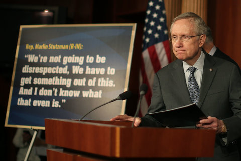 Harry Reid stands next to a quote from Marlin Stutzman during a news conference in Washington, D.C., on Oct. 3, 2013. 