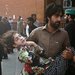 A man carried a girl to a hospital after a bomb exploded near a polio vaccination team on Monday in Peshawar, Pakistan.