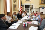 President Barack Obama meets with senior staff in Chief of Staff Denis McDonough's office in the West Wing of the White House, Sunday, Sept. 29, 2013.