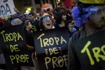 Protesters shout slogans holding banners that reads 'Teachers squad" during a march in support of teachers on strike in Rio de Janeiro, Brazil, Monday, Oct. 7, 2013.