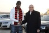 Mario Balotelli, left, shakes hands with AC Milan vice president Adriano Galliani upon his arrival at the Milan Malpensa airport, Italy, Wednesday, Jan. 30, 2013. Italy striker Mario Balotelli landed in Milan to finalize his move from Manchester City to AC Milan on Wednesday. Milan announced on Tuesday that it reached an agreement with City and that Balotelli would sign a 4 1/2-year deal following a medical exam. "It's been a long time that I've wanted to play for Milan, but obviously I was playing for other clubs so I couldn't come here," Balotelli said, wearing a Milan scarf around his neck. "Now I had the opportunity and I ran."