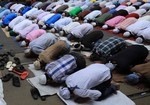 Indian Muslims offer Friday prayers during the holy month of Ramadan on the road in Kolkata on July 26, 2013. Islam's holy month of Ramadan is calculated on the sighting of the new moon and Muslims all over the world are supposed to fast from dawn to dusk during the month