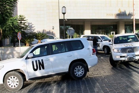 A convoy of chemical weapons disarmament experts depart the Four Seasons Hotel in Damascus, Syria, Tuesday, Oct. 8, 2013.