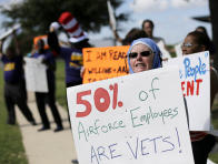 Protesters for federal workers idled by the government shutdown gather outside the San Antonio office of U.S. Sen. Ted Cruz, R-Texas, Thursday, Oct. 3, 2013, in San Antonio. (Photo by Eric Gay/AP)