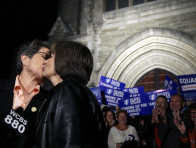 In this Sept. 27, 2013 file photo, Cindy Meneghin, left, kisses her partner Maureen Kilian, both from Butler, N.J., during a news conference at Garden State Equality in Montclair, N.J., hours after a Superior Court Judge ruled that New Jersey is unconstitutionally denying federal benefits to gay couples and must allow them to marry. (Photo by Julio Cortez/AP)