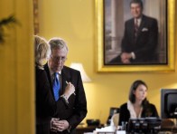 Senate Minority Leader Mitch McConnell talks to an unidentified person in his office before a closed-door meeting of Senate Republicans on Capitol Hill on Oct. 9, 2013.  (Photo by Susan Walsh/AP)