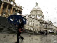 A man with an umbrella walks as it rains at the U.S. Capitol in Washington October 10, 2013. U.S. House of Representatives Republicans are weighing a short-term debt limit increase with no added policy changes, such as deficit-reduction requirements, according to a source with knowledge of the discussions. (Photo by Jonathan Ernst/Reuters)