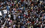 File: Volunteers carry an unconscious devotee to an ambulance, believed to have been injured in a stampede.