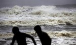 Indian people run for shelter following a cyclone warning at the Bay of Bengal coast in Gopalpur beach in Ganjam district about 200 kilometers (125 miles) from the eastern Indian city Bhubaneswar, India, Saturday, Oct. 12, 2013.