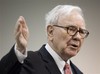 In this May 2, 2009 file photo, Warren Buffett, CEO of Berkshire Hathaway, speaks to a reporter before the annual Berkshire Hathaway shareholders meeting in Omaha