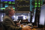 A man works at a computer at the stock market in Barcelona, Spain, Thursday April 29, 2010. The European debt crisis spread Wednesday when Standard & Poor's lowered its credit rating for Spain amid concerns about the country's growth prospects following the collapse of a construction bubble.