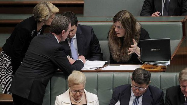 Frontbenchers Christopher Pyne and Julie Bishop talk with Peta Credlin, chief of staff to Opposition Leader Tony Abbott, during question time on Wednesday.