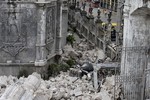 The bell of Basilica of the Holy Child lies amidst the rubble following a 7.2-magnitude earthquake that hit Cebu city in central Philippines and toppled the bell tower of the Philippines' oldest church Tuesday, Oct. 15, 2013.